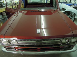 A red truck is parked in a garage.