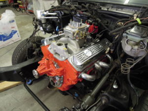 A car engine with the hood open and the engine bay exposed.