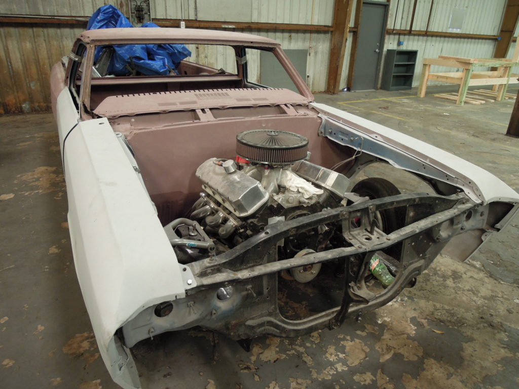 A car that is being worked on in the garage.