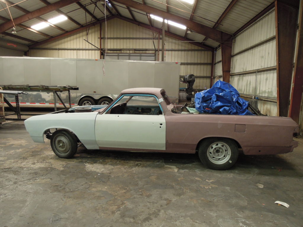 A car that is sitting in the back of a truck.