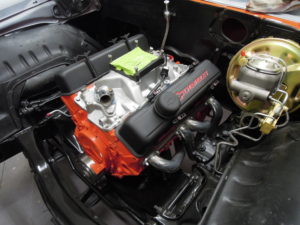 A close up of the engine compartment of an old car.