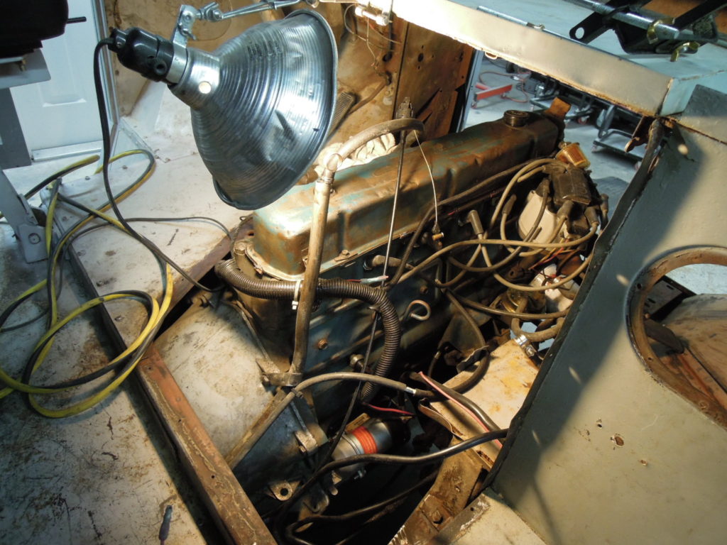 A motor is being worked on in the middle of a room.