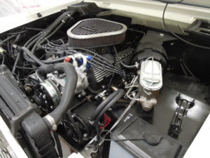 A car engine with the hood open.