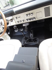 A car 's dashboard and the steering wheel.