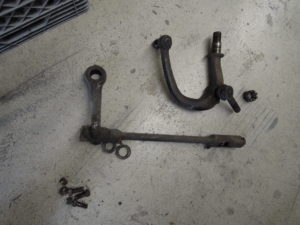 A pair of wrenches and other hardware on the floor.