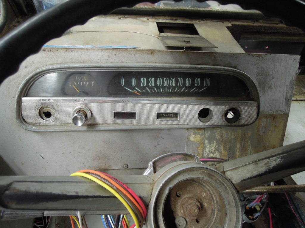 A close up of the dashboard of an old car