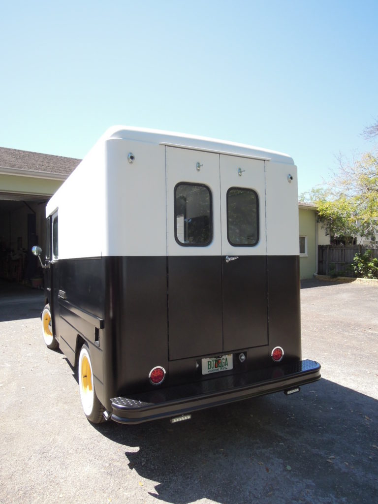 A black and white van parked in the driveway.