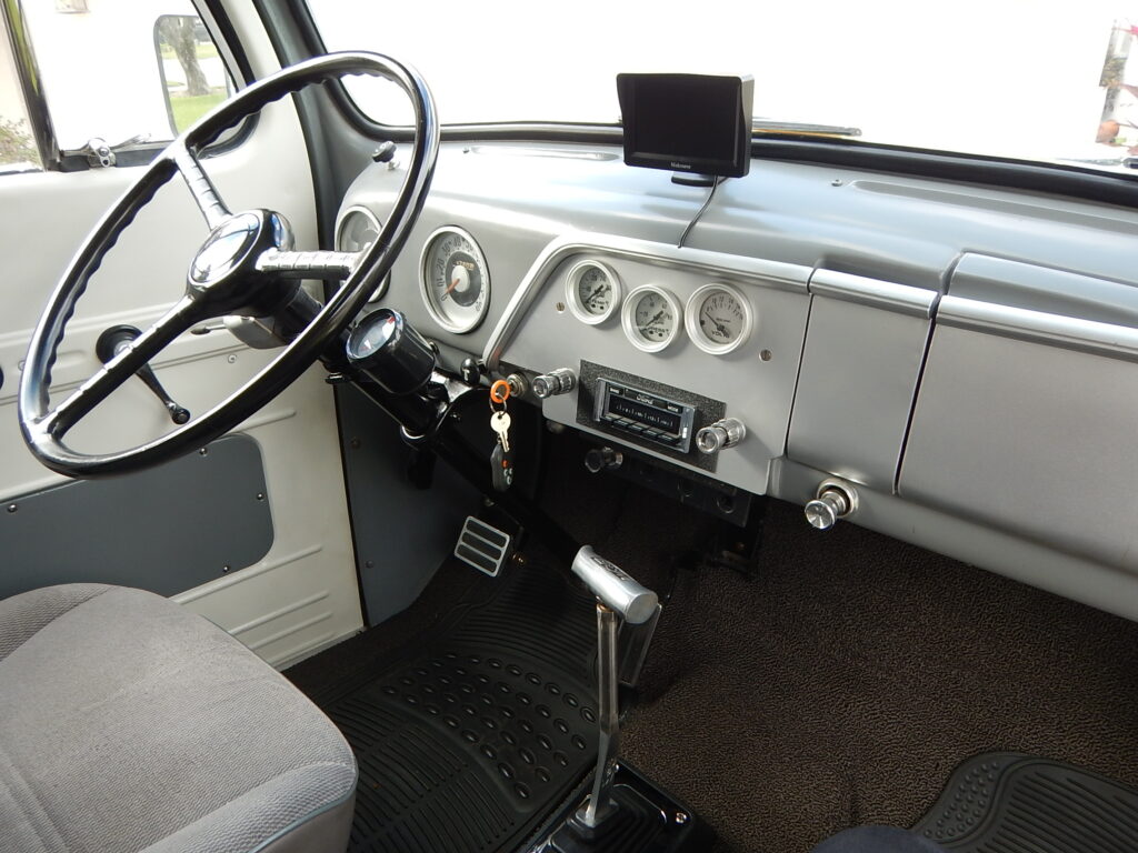 A truck with the steering wheel and dashboard in view.