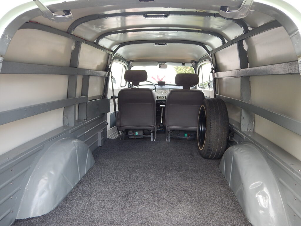 A van with many seats in the back of it