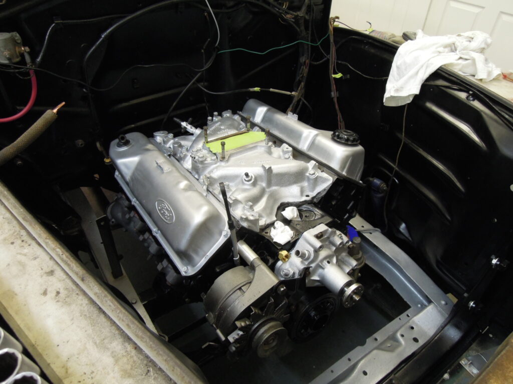 A car engine with the hood open.